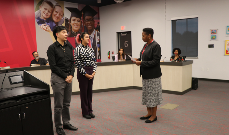 Board Secretary Kimberly Hatchett administered the oath to East High School seniors Daniela Arredondo and Arturo Samano.  