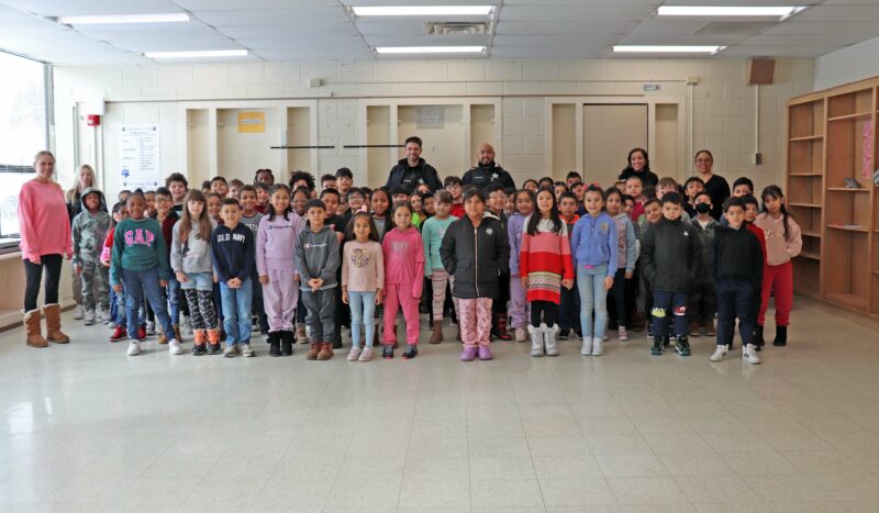 Second graders pose with Officer Baluyut and Officer Nardone.